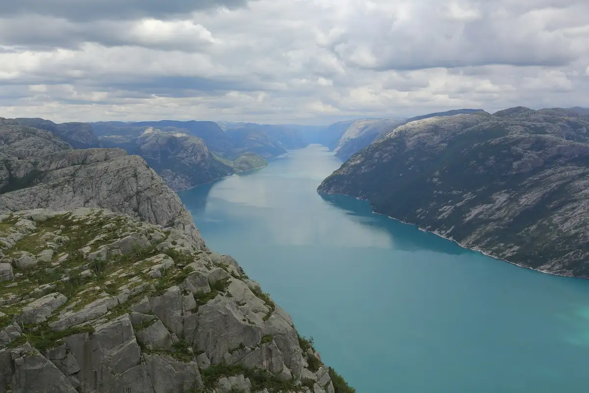 Wide view of Lysefjord in Norway with steep fjord walls and calm water.