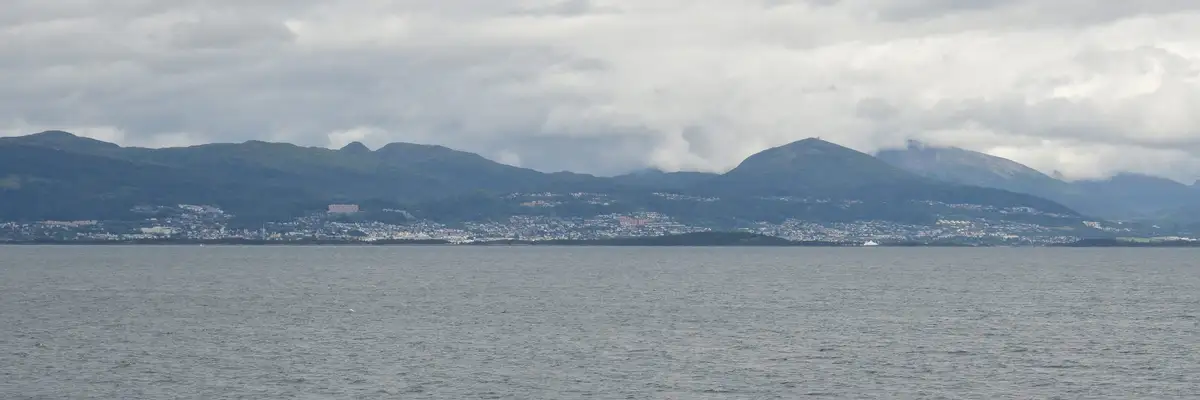 Molde seen from the fjord with the mountain panorama behind.