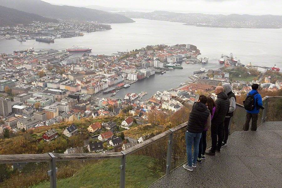 Visitors at the Mount Fløyen viewing platform looking out over Bergen's harbour and the fjord.