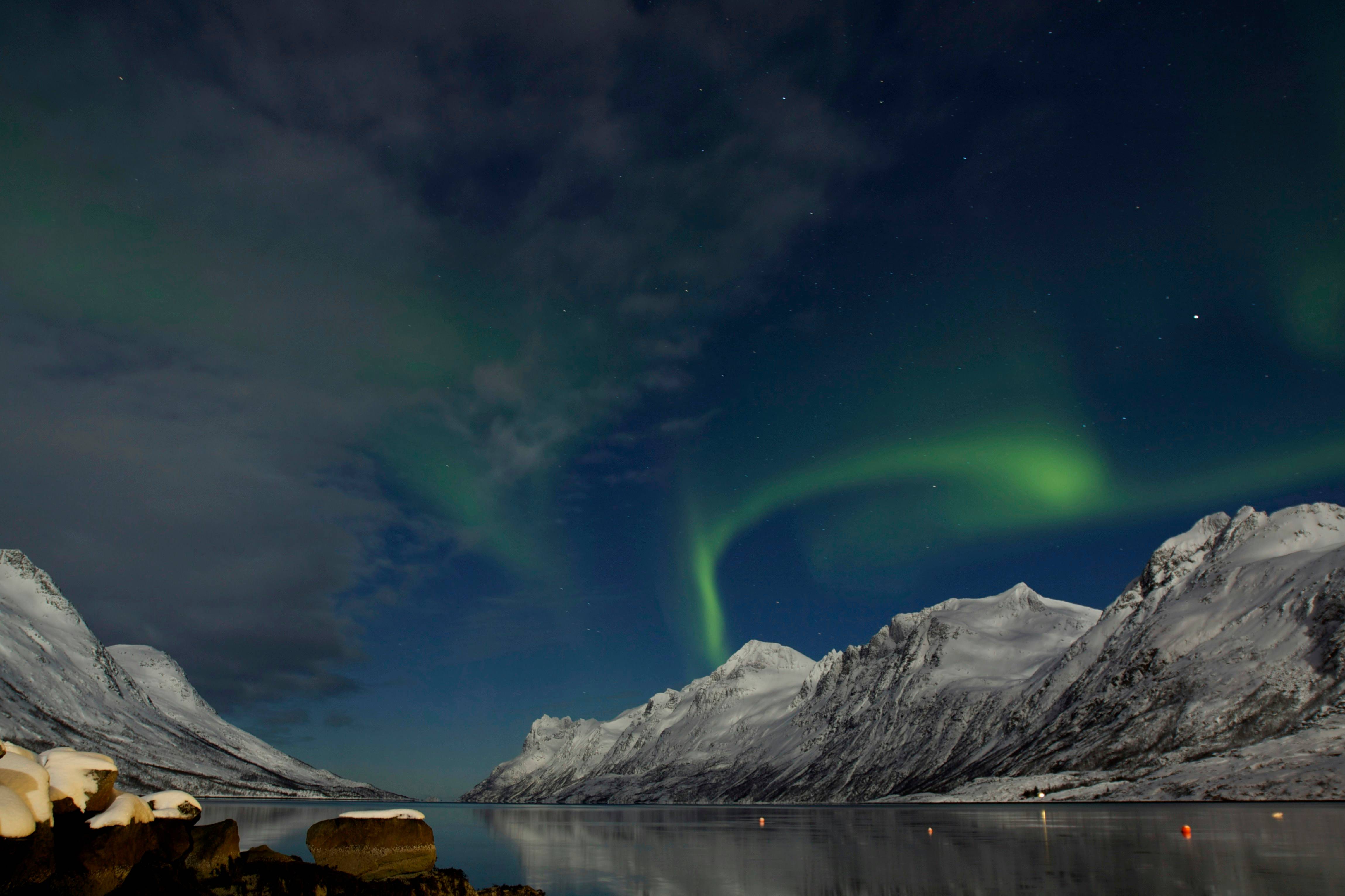 Northern lights over a fjord near Tromsø, Norway.
