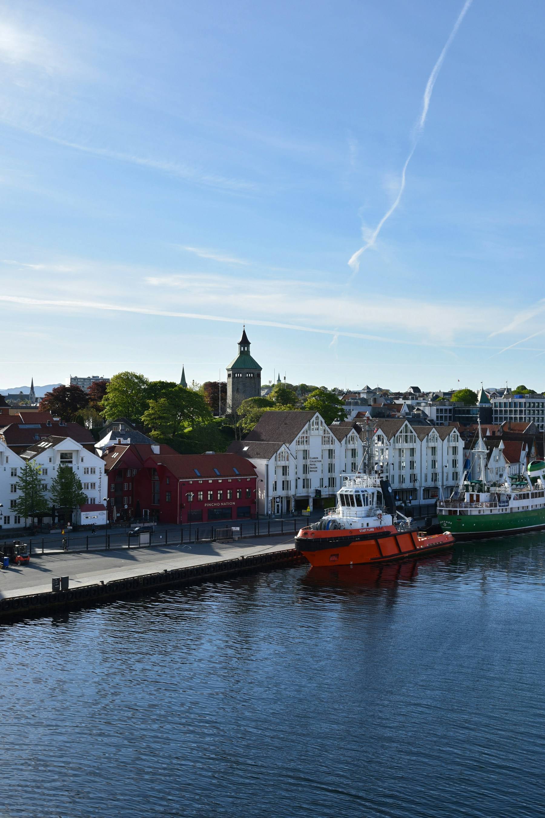 Stavanger harbour at Vågen with boats, waterfront warehouses, and Valberg Tower.