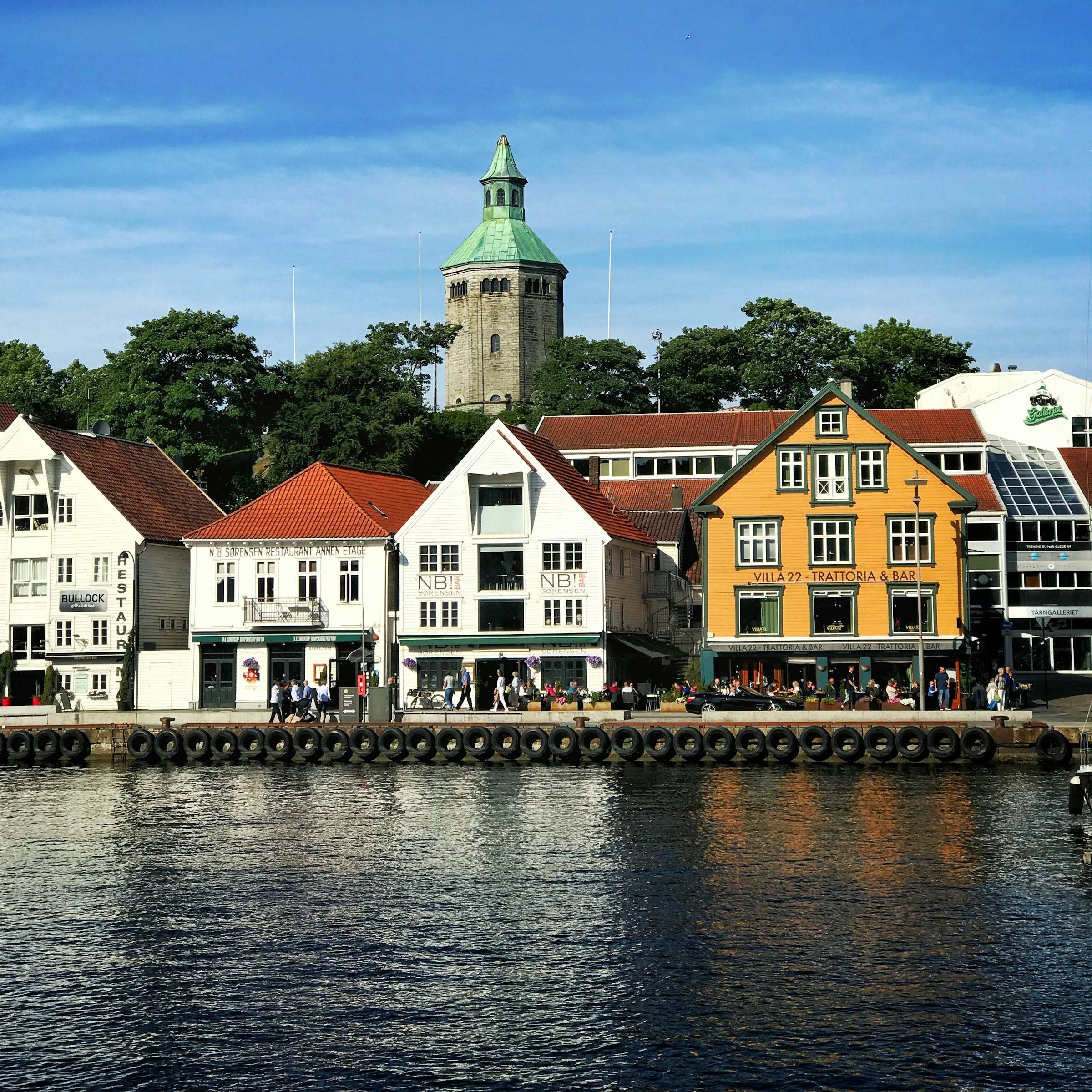 Harbour-front restaurants along Strandkaien in Stavanger, with Valberg Tower behind.